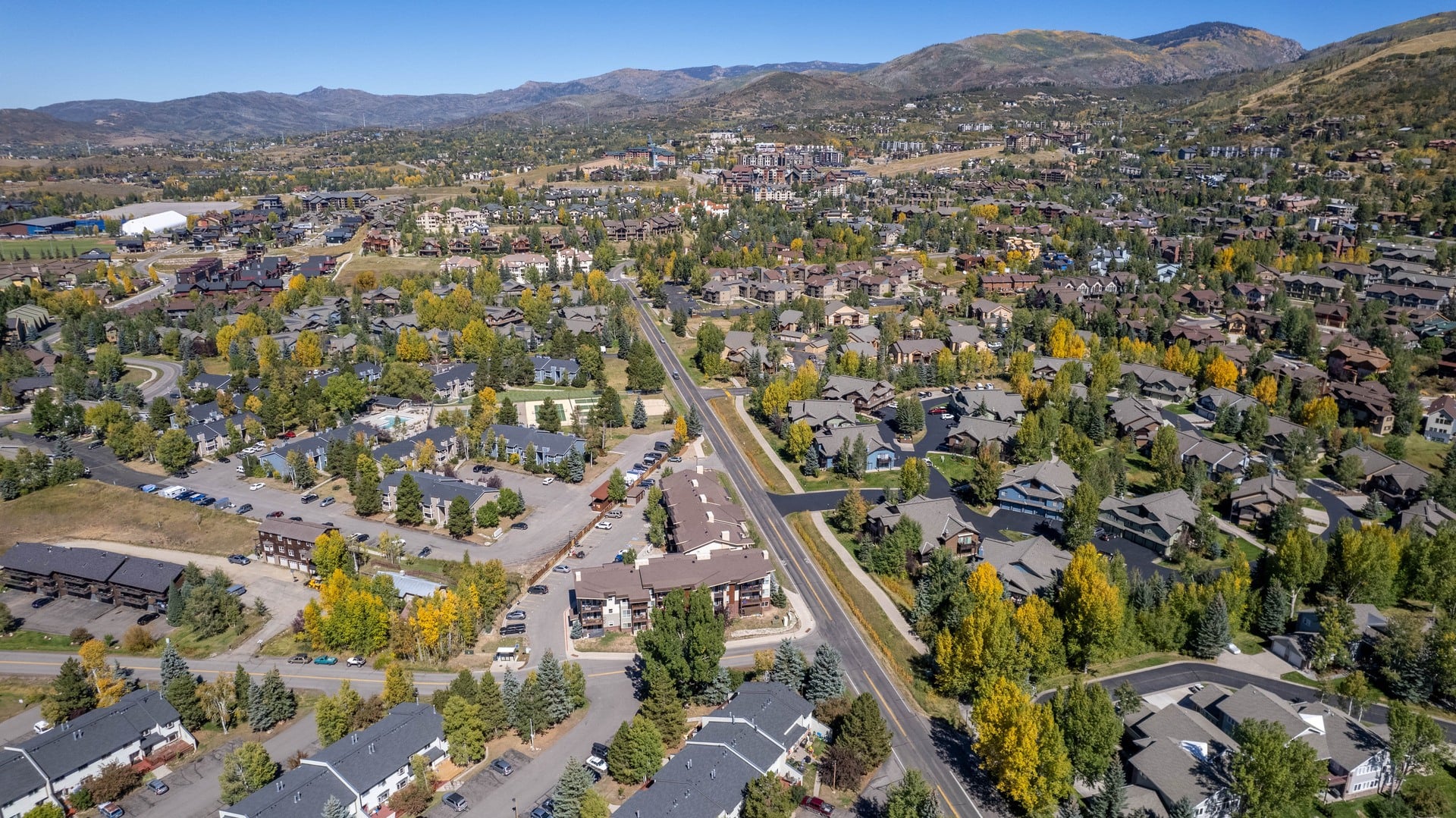 A small town with a lot of houses and a road going through it.